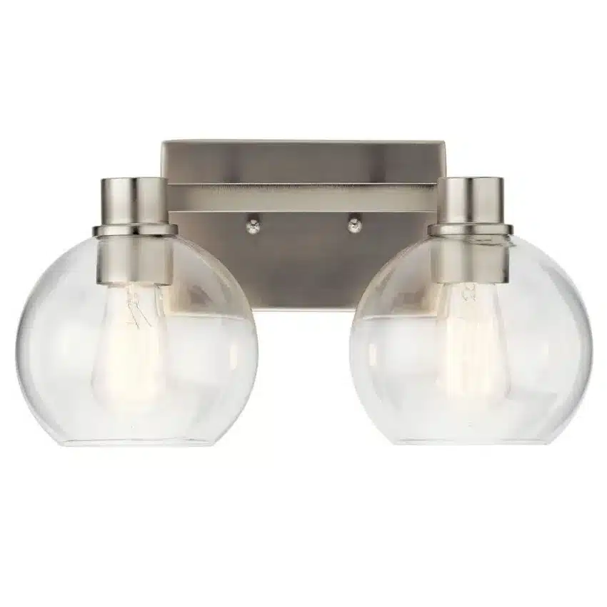 Le luminaire de salle de bain Harmony de 15,5 po à 2 lumières présente un style transitionnel intemporel caractérisé par des lignes épurées, des abat-jours en verre clair et un élégant fini nickel brossé. Grâce à son design sobre et polyvalent, Harmony s’intègre parfaitement à une variété de décors, qu’ils soient transitionnels, classiques ou traditionnels. Idéal au-dessus d’un lavabo ou d’un meuble-lavabo, il procure un éclairage fonctionnel tout en ajoutant une touche de raffinement à la pièce.